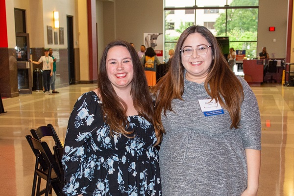 Two alumni at an alumni event smiling