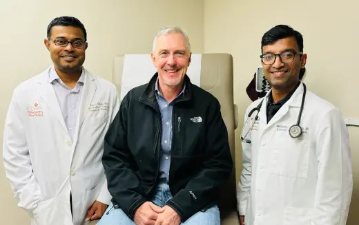 Interventional cardiologists Abhijeet Dhoble, MD, (left), and Muhammad Khan, MD, (right), were part of a UTHealth Houston team of experts who treated patient Brenton Parr after he suffered a major stroke. (Photo by UTHealth Houston)