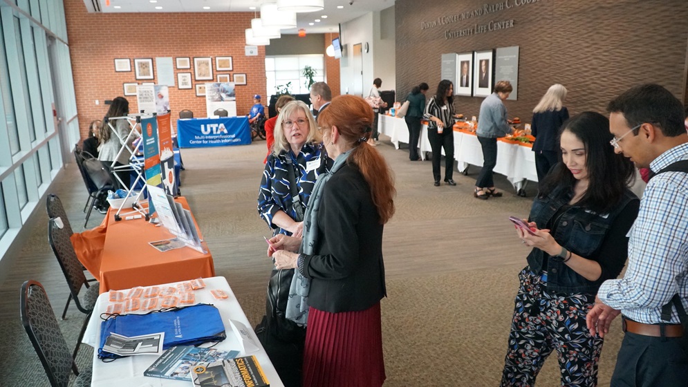 Group of people gathered near a registration table for an event