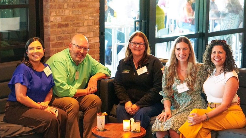 5 McGovern Medical School alumni sitting together at an event