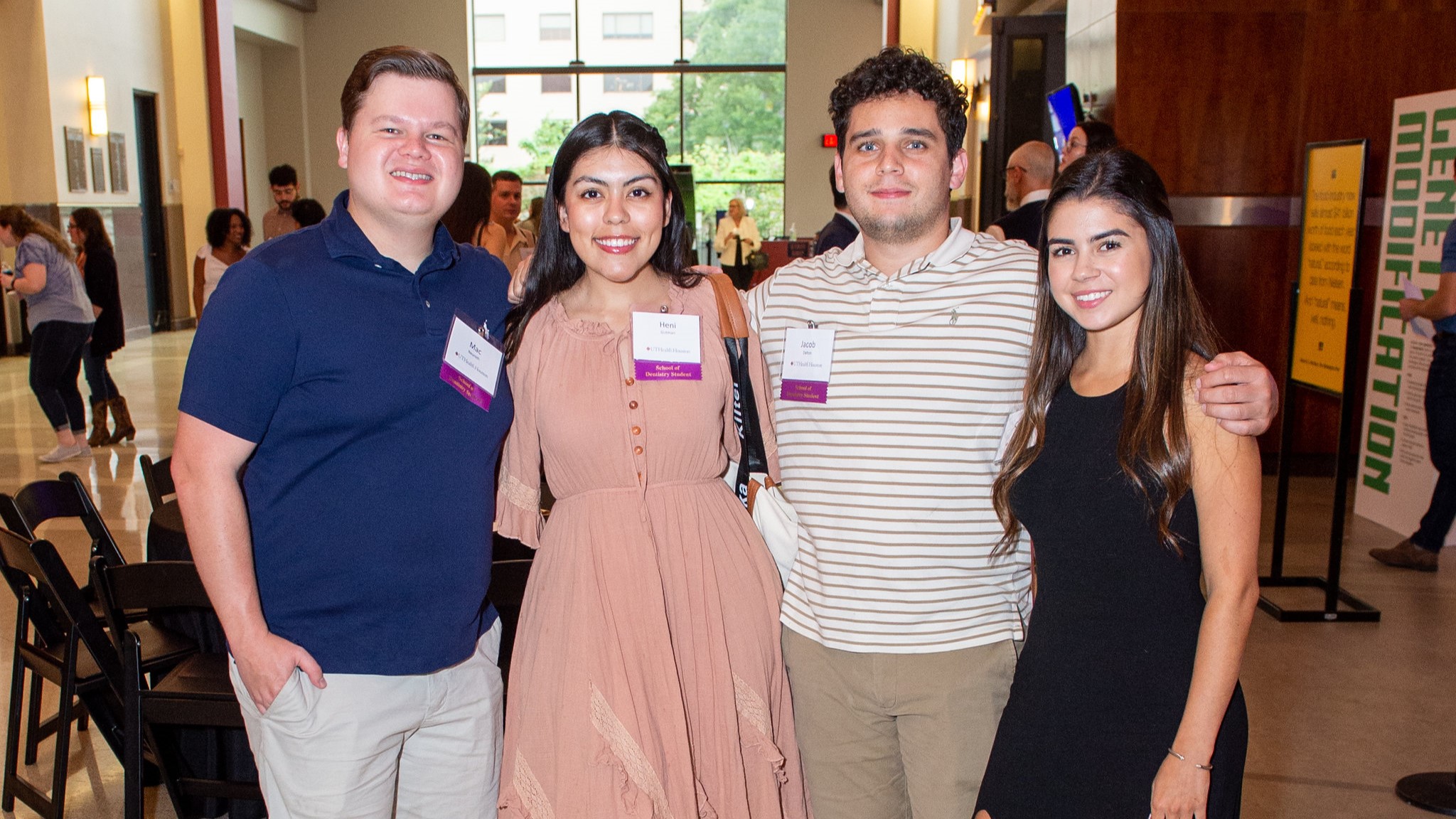 Four School of Denistry students standing together posing for a photo