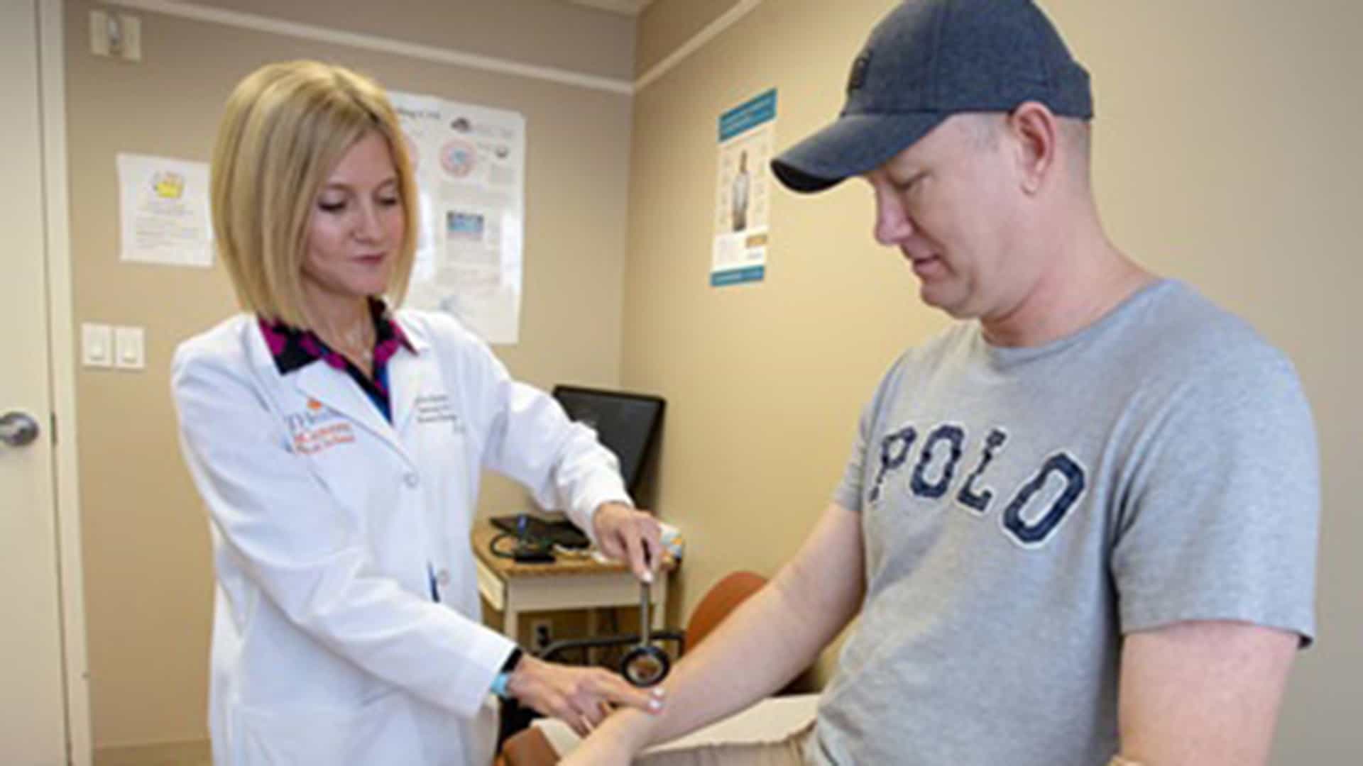 Female physician examining a male patient