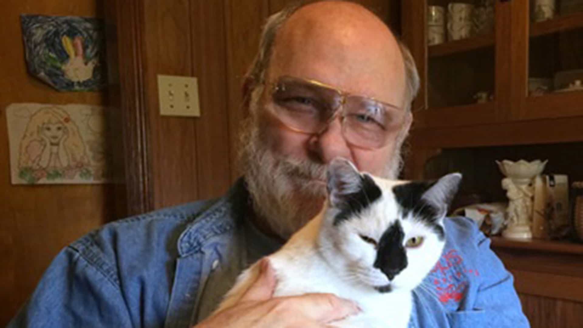 Myron Loop holding his pet cat